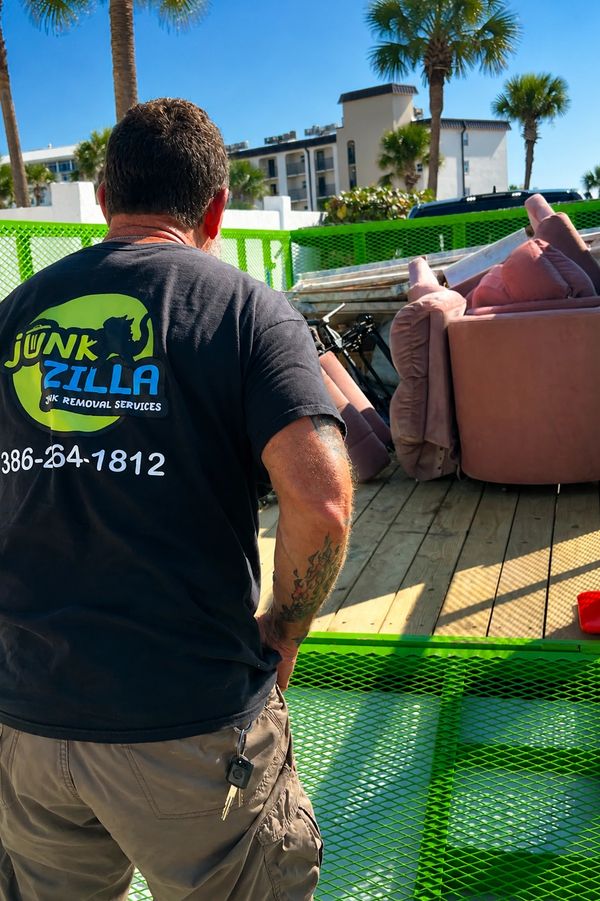 Tony loading furniture & misc junk into the Junk Zilla trailer for removal in Daytona Beach Shores