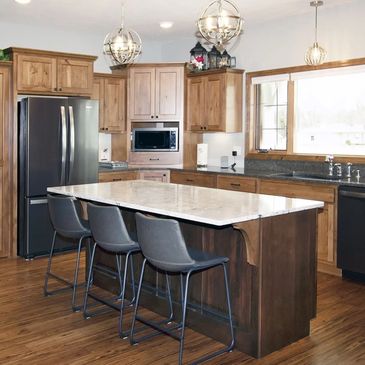 Sleek marble table with modern pendant lighting above

