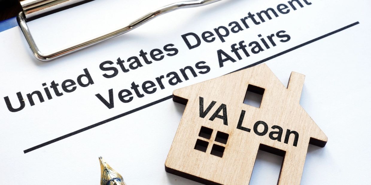 Wood House cutcut on a Clipboard with white paper that has typed lettering, USD of VA