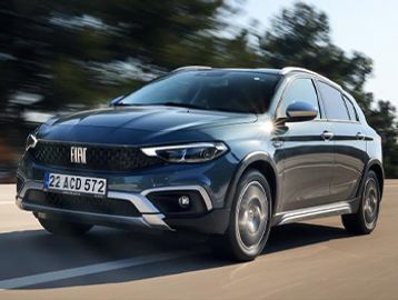 A blue Fiat SUV driving on a road with motion blur.