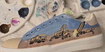 Historical Hand painted art pieces, boldly displayed on athletic footwear.