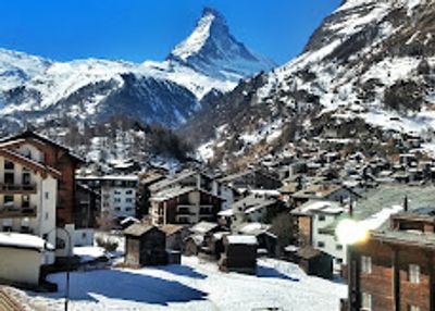 Snowy mountain village with Matterhorn peak in the background.