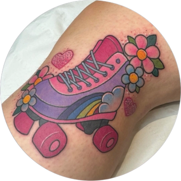 Colorful roller skate tattoo with flowers and hearts.