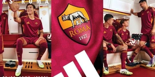 AS Roma players showcasing the 25/26 home jersey in the locker room.