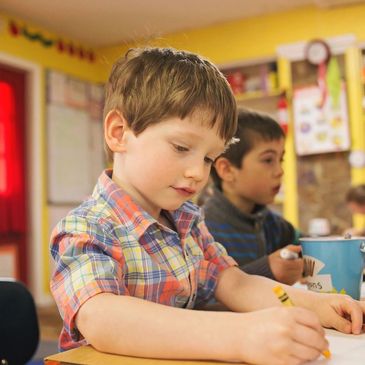 Children focused on individual work in a preschool classroom