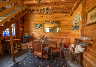Rustic wooden dining room with vintage furniture and decorations.