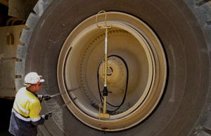 Show a mine worker removing a locking ring