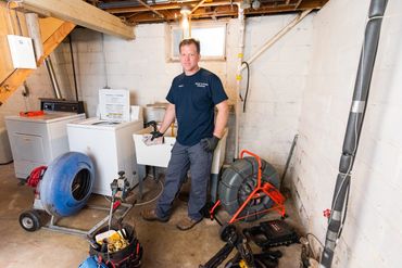 a man working in the basement of a house 