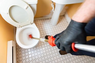 a person cleaning a commode 