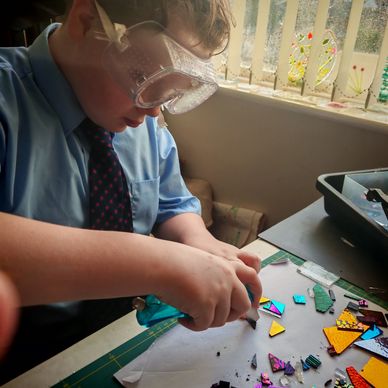 Zander cutting glass using a glass cutter 