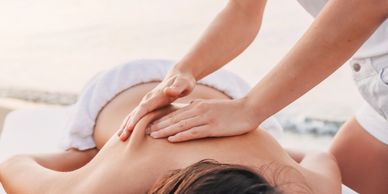 a woman getting a Swedish Massage from a lady 
