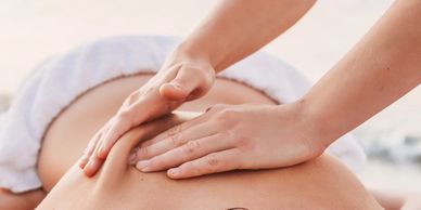a woman getting a Swedish Massage from a lady 
