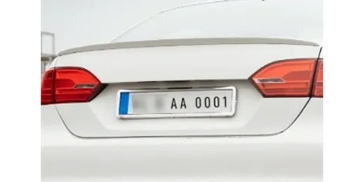Rear view of white car with license plate AA 0001.