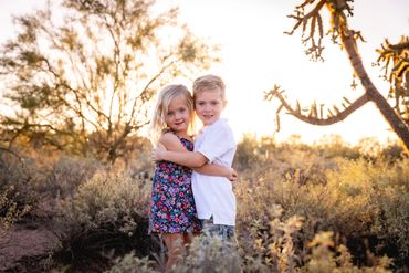 Sibling photoshoot; brother and sister hugging sunset desert photography