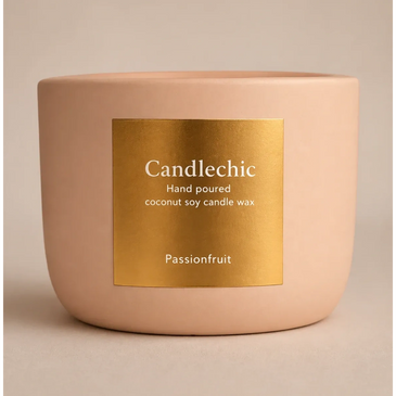 Minimalist pink ceramic candle with gold label, hand-poured passionfruit scent.
