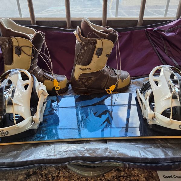 Snowboard with boots and bindings in a bag.