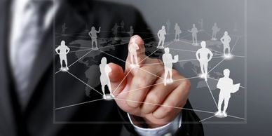 Businessman interacting with digital network of connected people icons.
