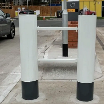 A white and black barrier gate at a parking exit.