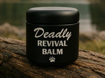 A black jar labeled 'Deadly Revival Balm' on a log.