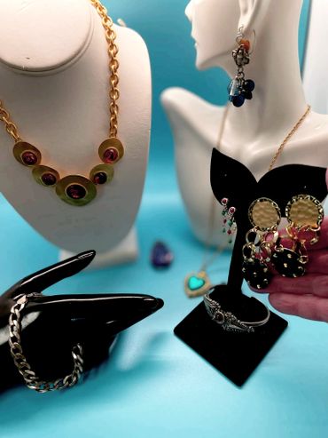 Display of various elegant jewelry pieces including necklaces, earrings, and bracelets.