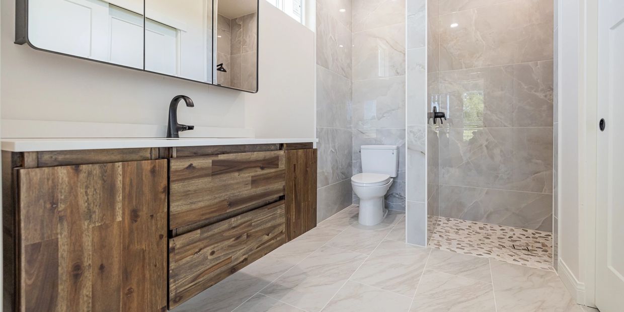 Tiled bathroom floor, shower and walls.