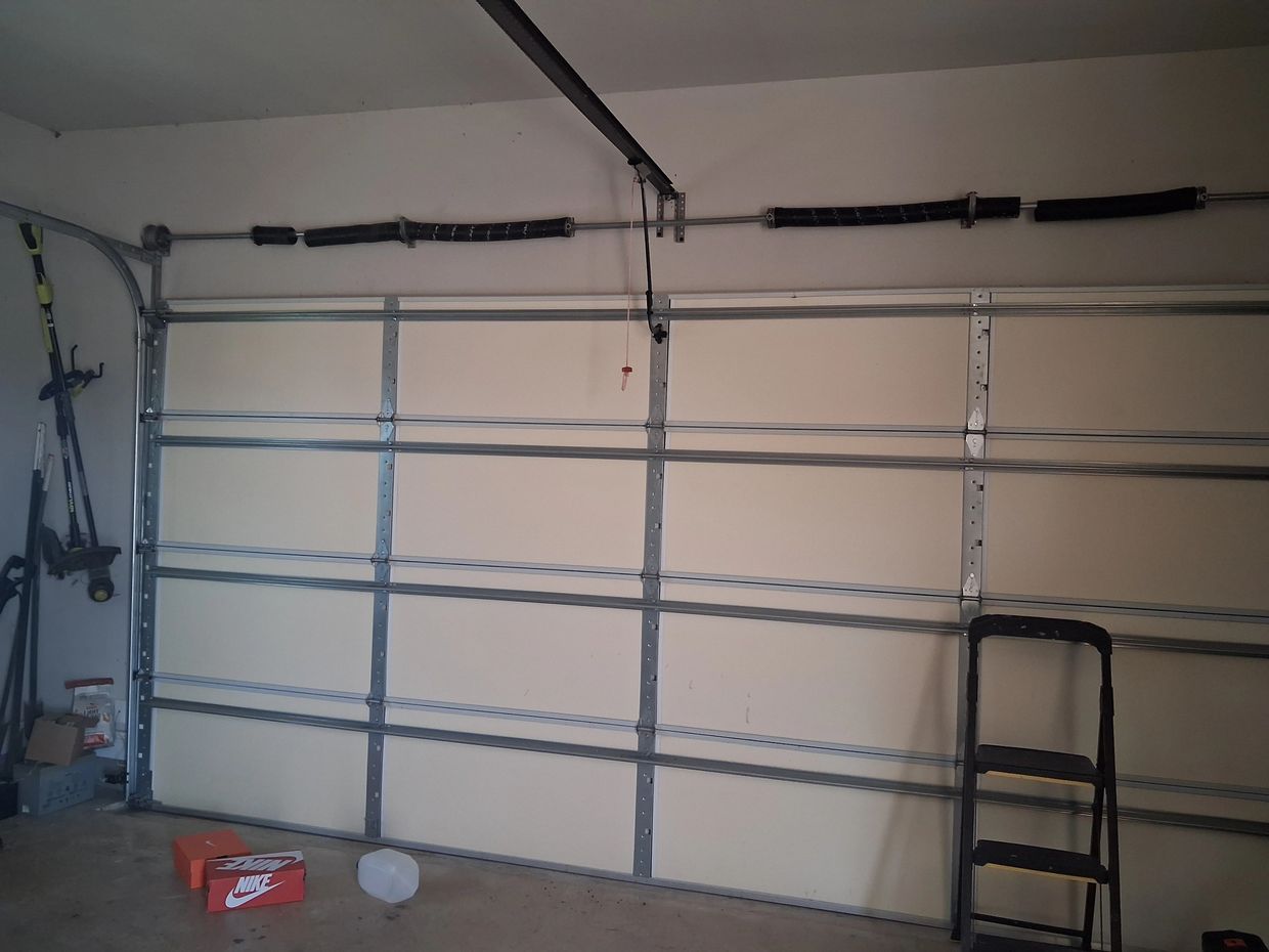 Broken garage door spring on wood garage door