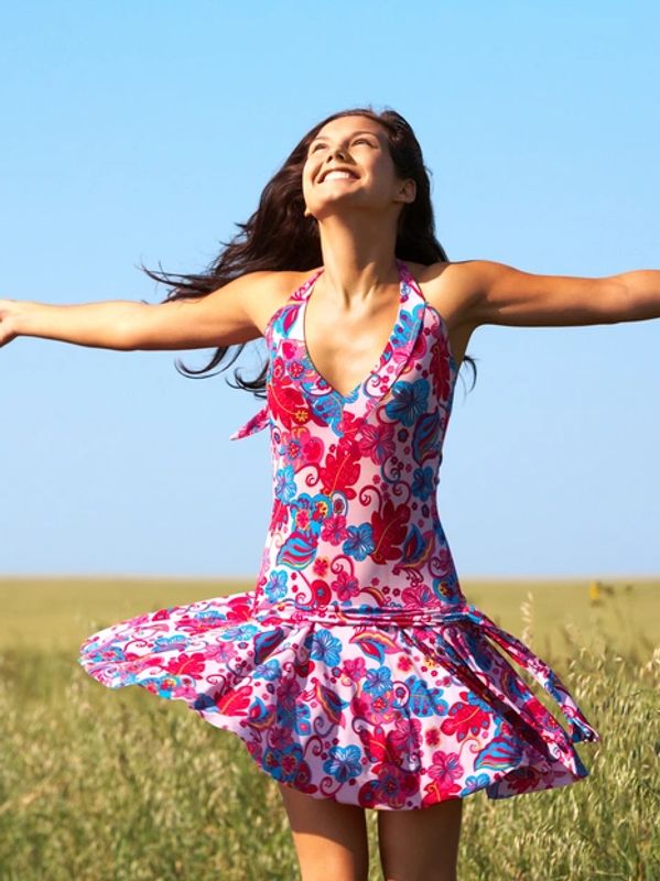woman joyfully embracing life in field 