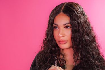 Portrait with pink paper background and pink gel lighting.