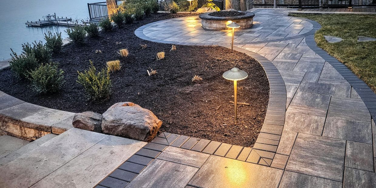 Expert outdoor lighting installation underway for a modern residential backyard.