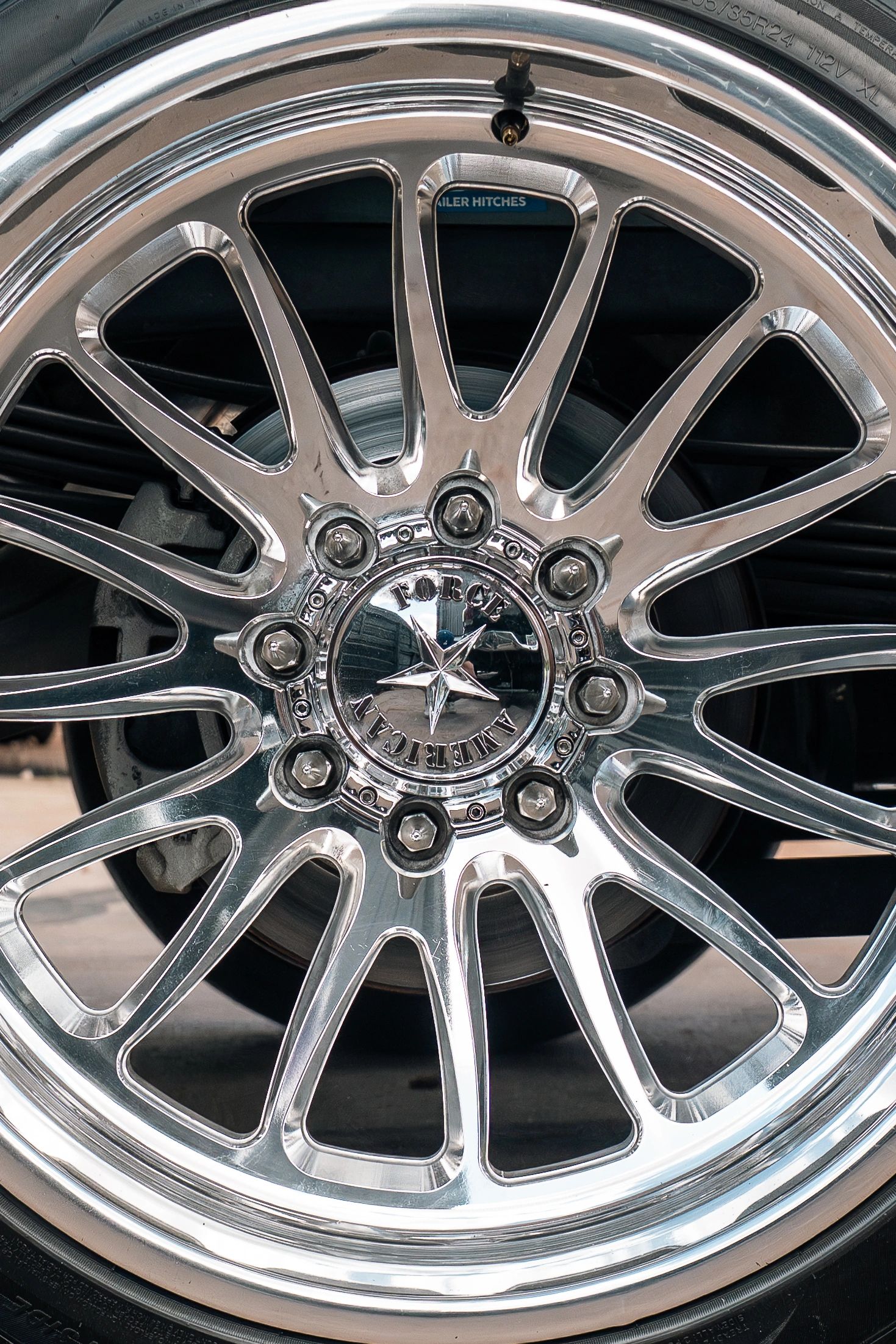 Close-up of a shiny, multi-spoke chrome car wheel rim.