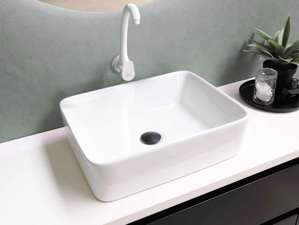 Modern white rectangular bathroom sink with a sleek white faucet.