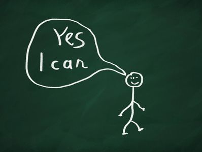 Chalk drawing of a smiling stick figure saying "Yes I can" on a green chalkboard.