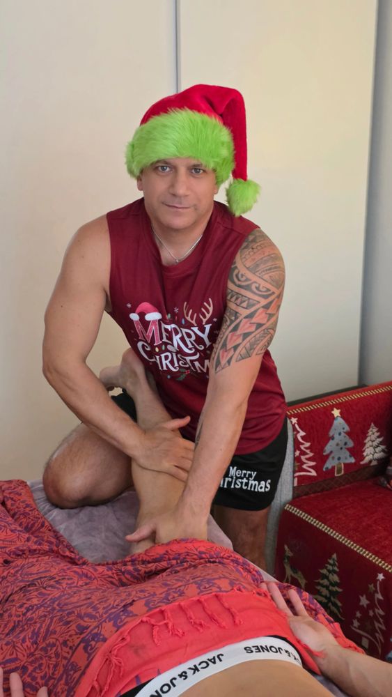 Massage therapist performing a professional leg massage in a private studio.