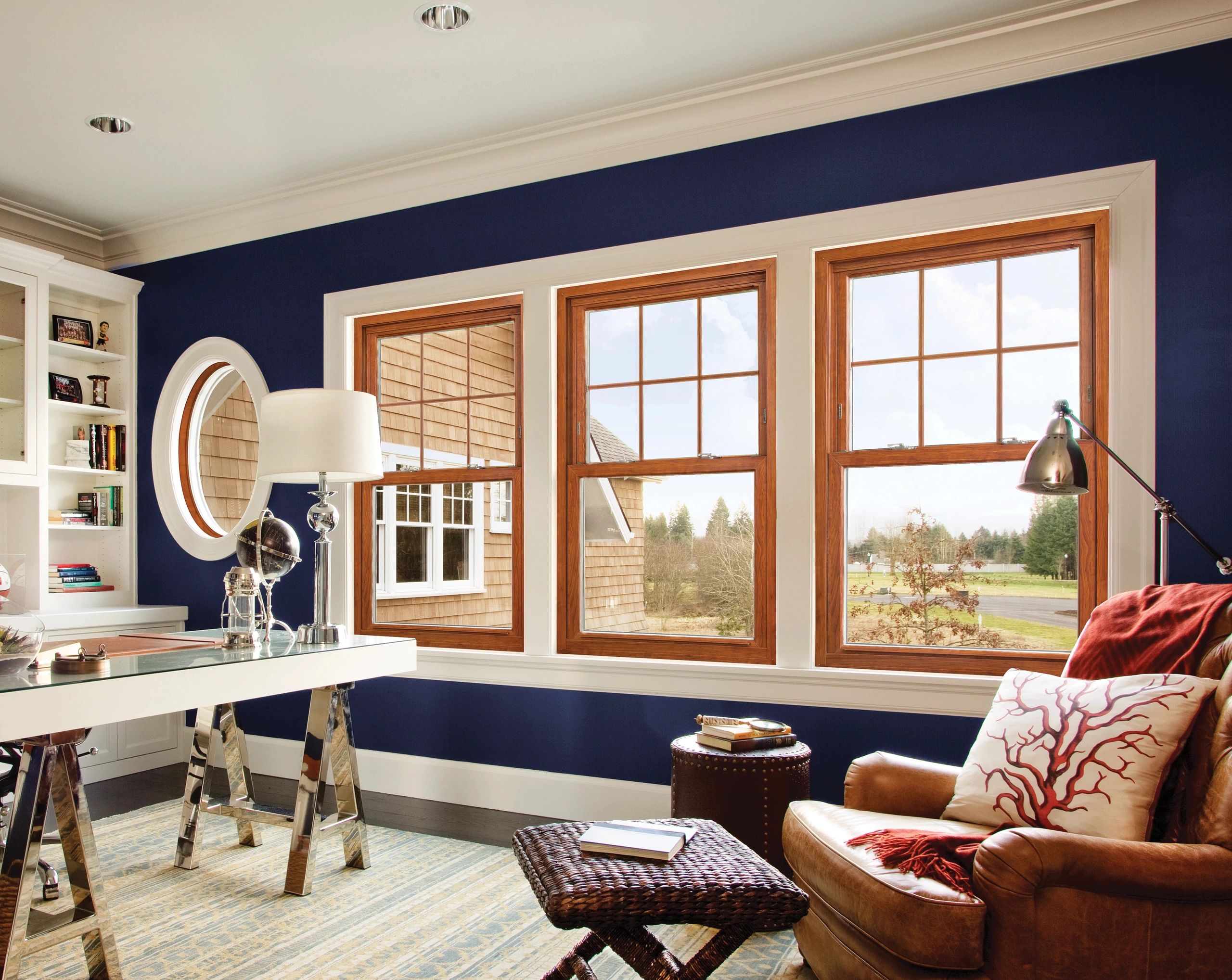 Alside Sovereign double-hung windows in Foxwood woodgrain with contoured colonial grids in top sash.