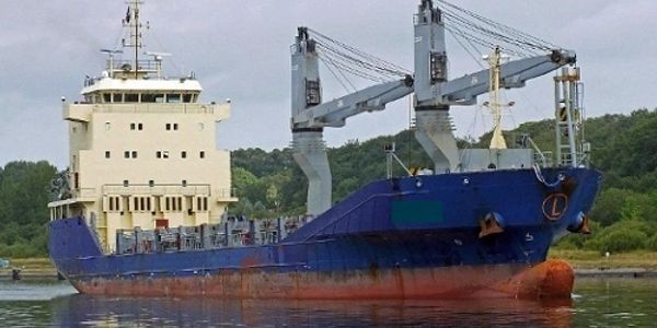 A cargo ship docked near shore.
