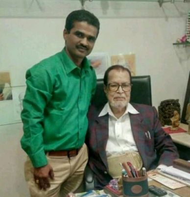 Two men posing in an office setting.