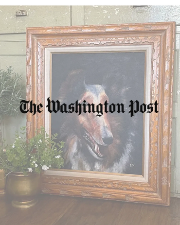 Framed painting of a collie dog with a wooden frame, placed on a wooden floor.