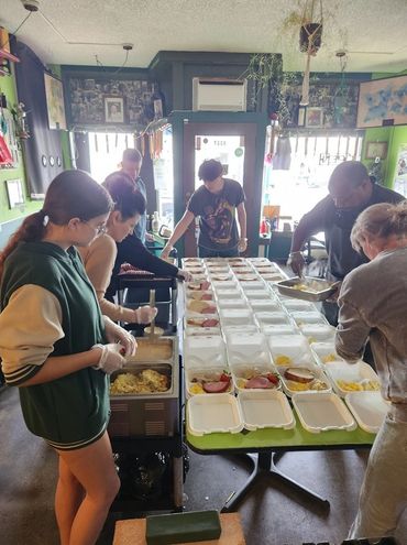 Title: Packing Meal Boxes for the Unhoused