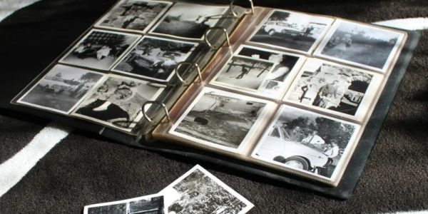 Old photo album with vintage black and white pictures.