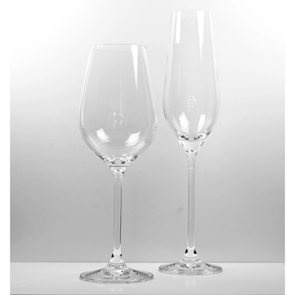Two elegant empty wine glasses on a white surface.