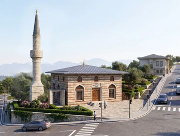 A mosque with a minaret at a street corner in a suburban area.