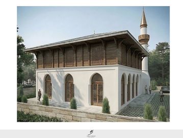 A historic mosque with white walls and wooden upper structure under a clear sky.