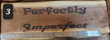 Engraved on black walnut and finished with polyurethane. Crack intentional. Measures 23" by 9"