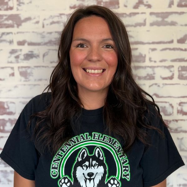 Woman smiling in a Centennial Elementary shirt.