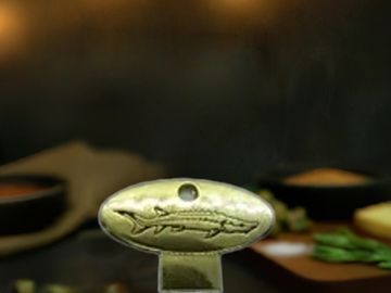 A sleek, golden caviar tin opener—effortless elegance for every indulgence.