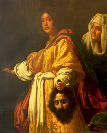 A person holding a severed head with a woman behind them.