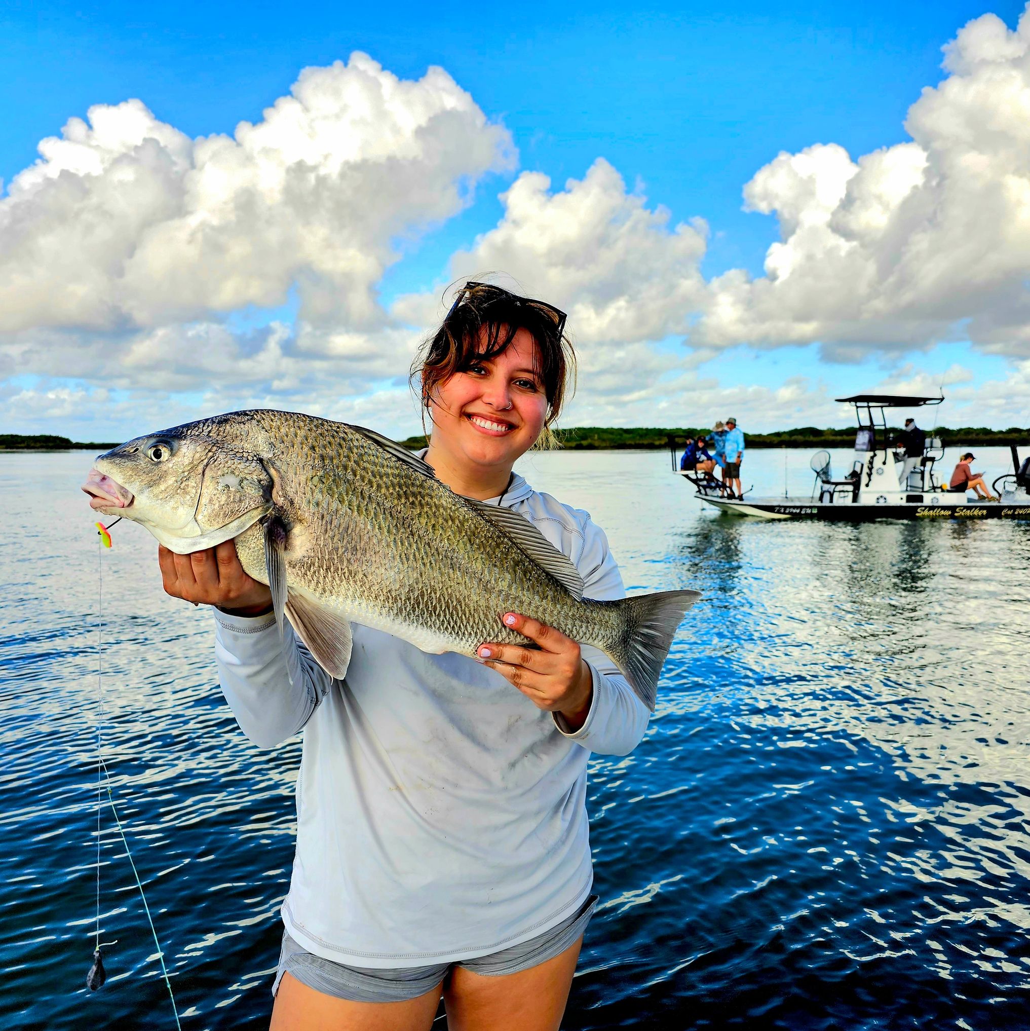 Large Black Drum held by Alondra Fleming Fishing South Padre Island 
River Watchers specialist