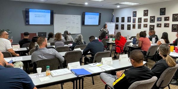 A classroom session with students and an instructor speaking.