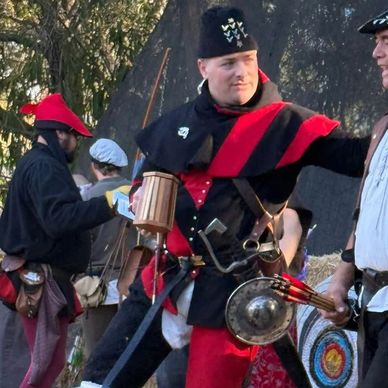 Men in historical military costumes at a reenactment event.