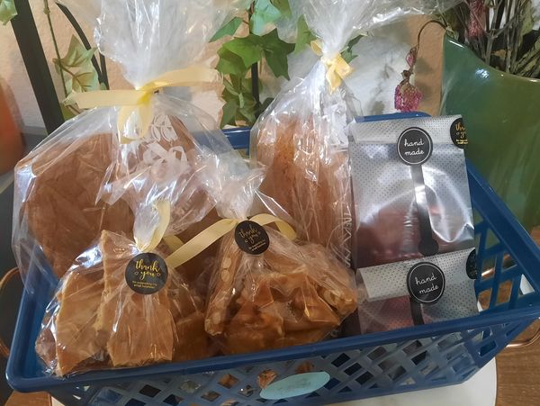 Gift basket with pumpkin bread loaves, peanut brittle and homemade fudge.